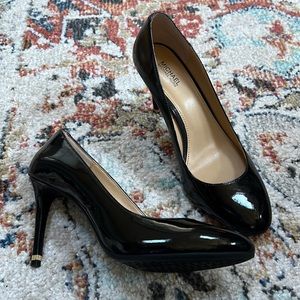Black Michael Kors pumps with gold heel detail